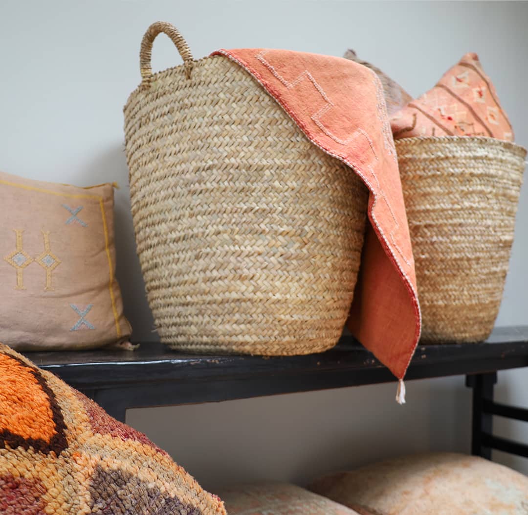 Handwoven baskets with a draped vintage kilim